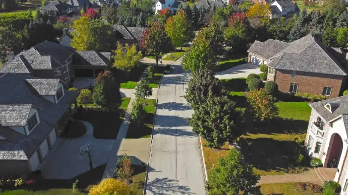 Aerial view of an established Northern Illinois neighborhood showing consistent single-family homes and tree-lined residential streets.